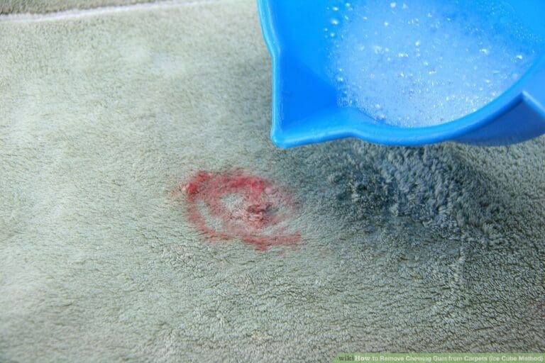a slime on carpet and a person adding a solution on it to clean slime.
