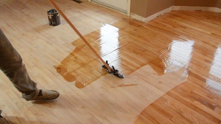 a person is polishing the hardwood floor.