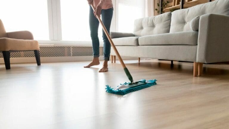 a person is cleaning a hardwood floor with mop