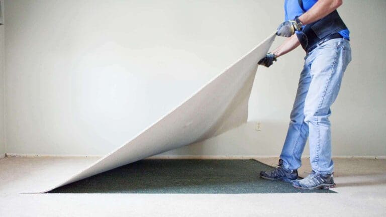 a person is removing carpet from the floor